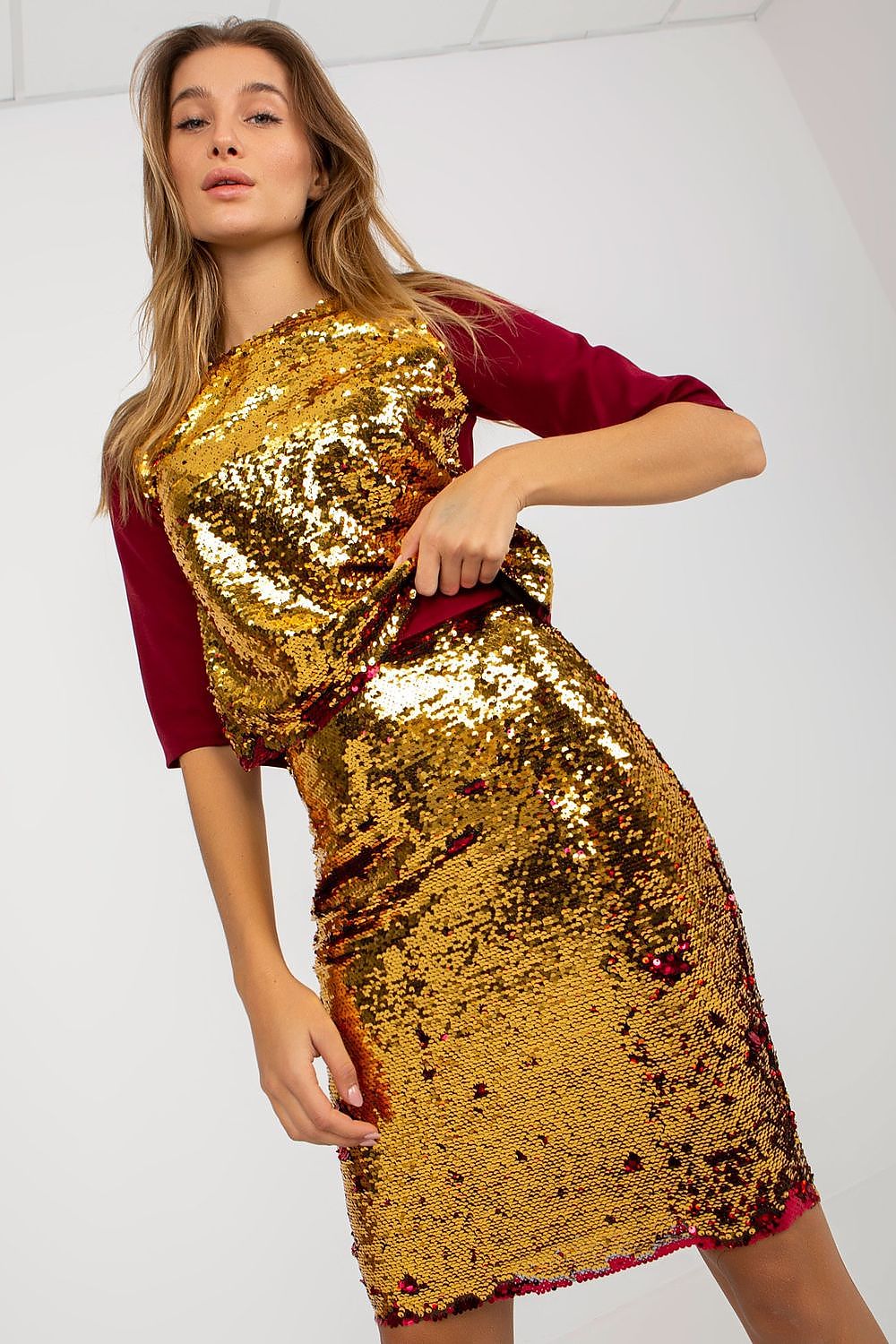Luxury sequined pencil skirt by Lakerta, showcasing its shimmering golden sequins and chic pencil cut, perfect for elegant evening wear.