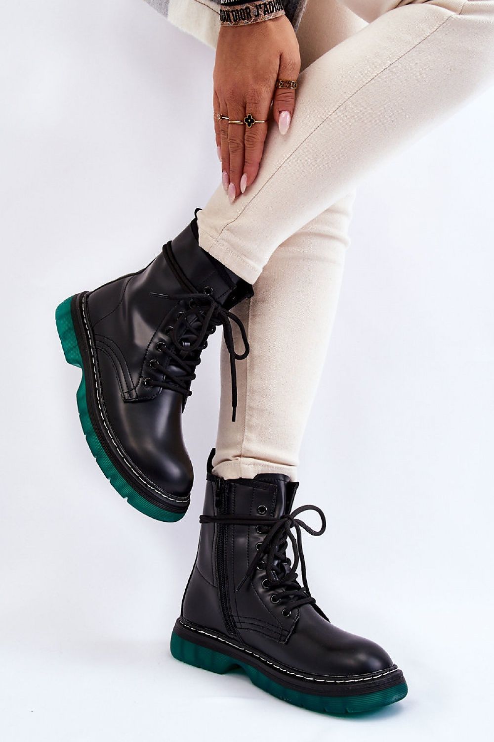 A pair of luxury Amski Gland Style Boots featuring an eco leather look, set against a minimalist background. The boots have a sleek design with a non-slip rubber sole and a comfortable insulated interior. Shown in an elegant outfit with light-coloured skinny trousers, these boots are perfect for adding a stylish touch to any ensemble.