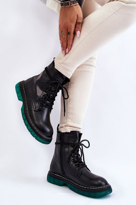 A pair of luxury Amski Gland Style Boots featuring an eco leather look, set against a minimalist background. The boots have a sleek design with a non-slip rubber sole and a comfortable insulated interior. Shown in an elegant outfit with light-coloured skinny trousers, these boots are perfect for adding a stylish touch to any ensemble.