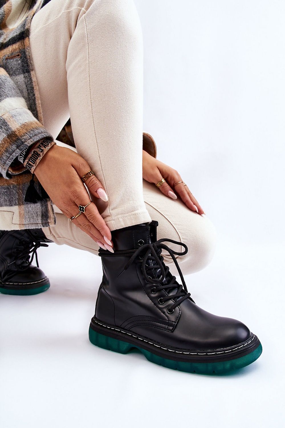 Luxurious Amski gland style boots in eco leather look, featuring a non-slip rubber sole, elegantly paired with light-coloured trousers. The boots showcase a classic lacing system complemented by a chic zipper closure for style and comfort.