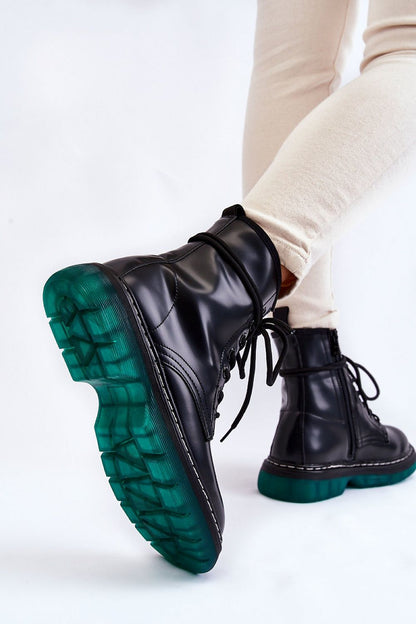 Close-up view of the Amski gland style boots highlighting the striking non-slip rubber sole with a unique green colour, designed for ultimate comfort and stability. The boots are elegantly styled with flat heels made to complement any sophisticated outfit.