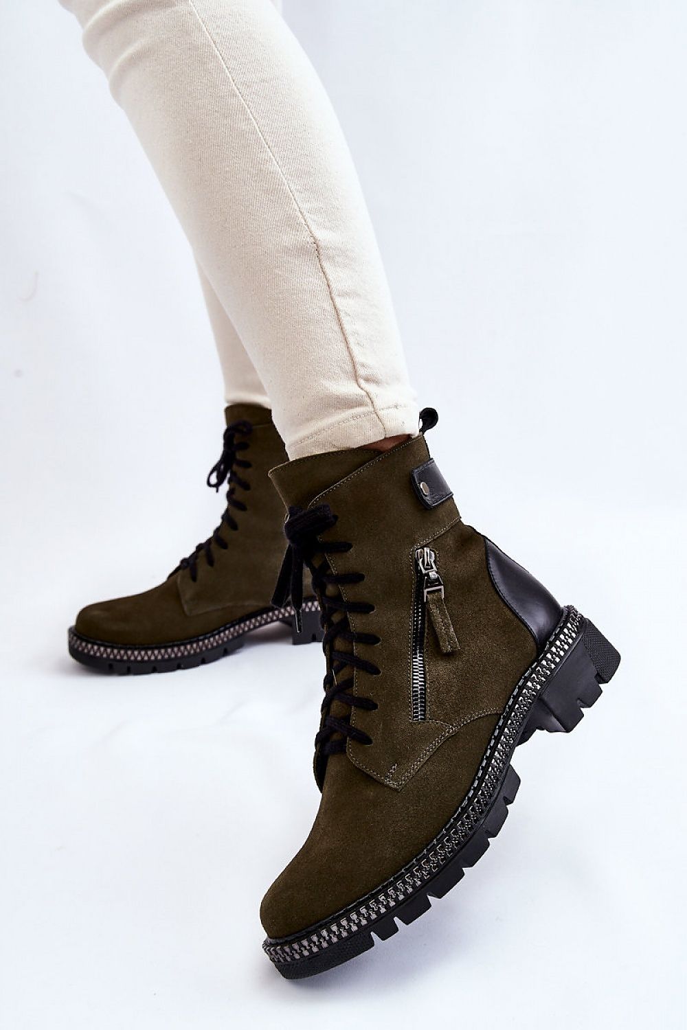 Fashion-forward women's suede leather ankle boots in olive green, featuring a sleek side zipper and flat heel, designed for both style and practicality, ideal for luxurious winter wear.