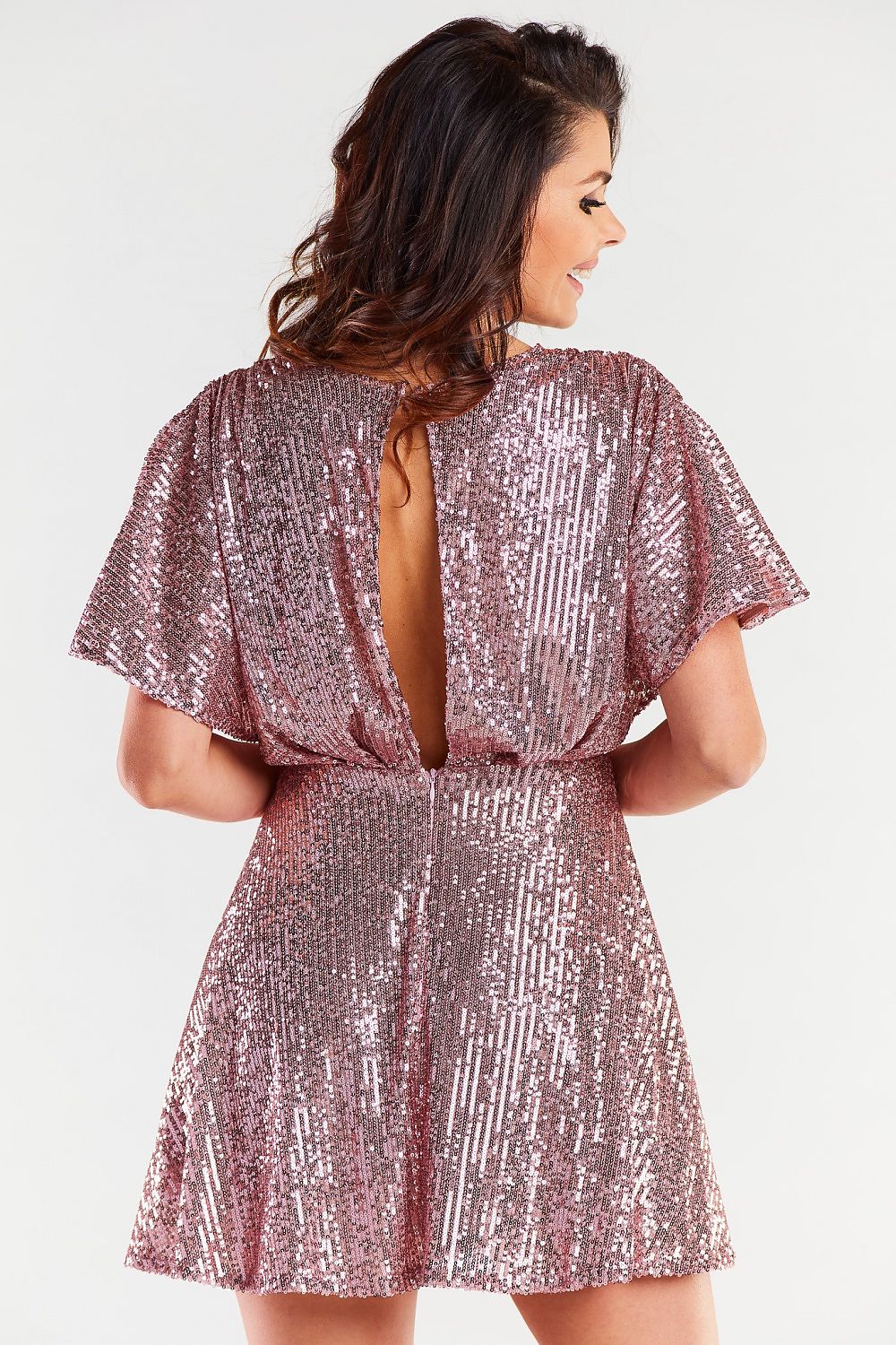 Chic back view of a rose gold evening dress with a fitted waist, highlighting its luxurious design and back fastening detail.