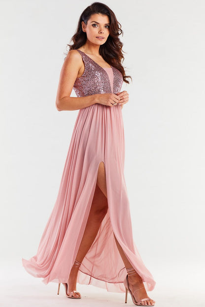 Stunning long pink dress with a glamorous open back and sequin accents, showcasing a side slit for a touch of sophistication and elegance.