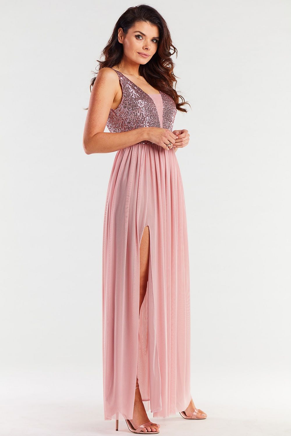 Exquisite long pink dress featuring an open back, adorned with sequins and delicate mesh details, elegantly draping to the floor.