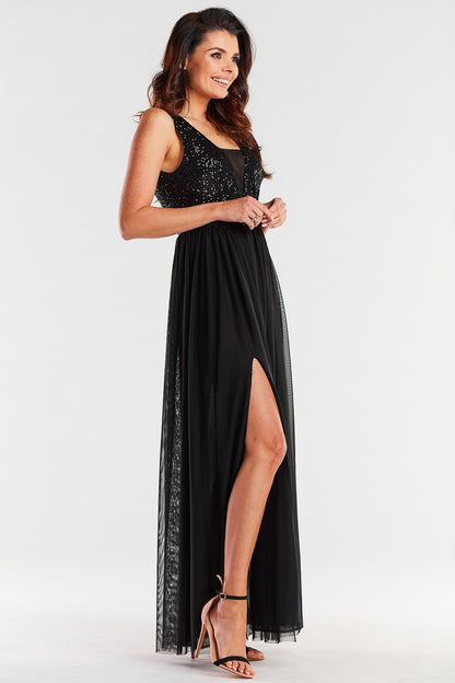 Charming black long dress with a deep v-neckline and sequin accents, elegantly styled with a thigh-high slit, perfect for formal occasions.