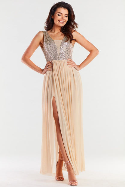 Stylish long beige dress adorned with sparkling sequins and flowing fabric, showcasing an elegant silhouette ideal for special occasions.