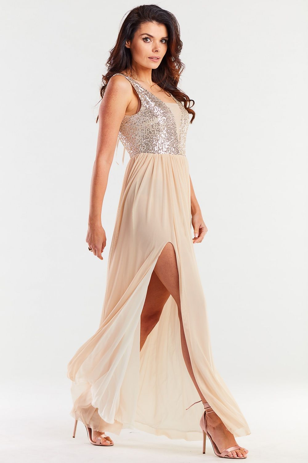 Graceful long beige dress with sequins on the bodice and a flowing skirt; a sophisticated choice for formal events.
