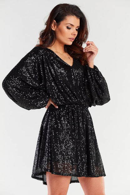 Elegant black loose evening dress with glittering detail, showcasing wide sleeves and a sophisticated silhouette.