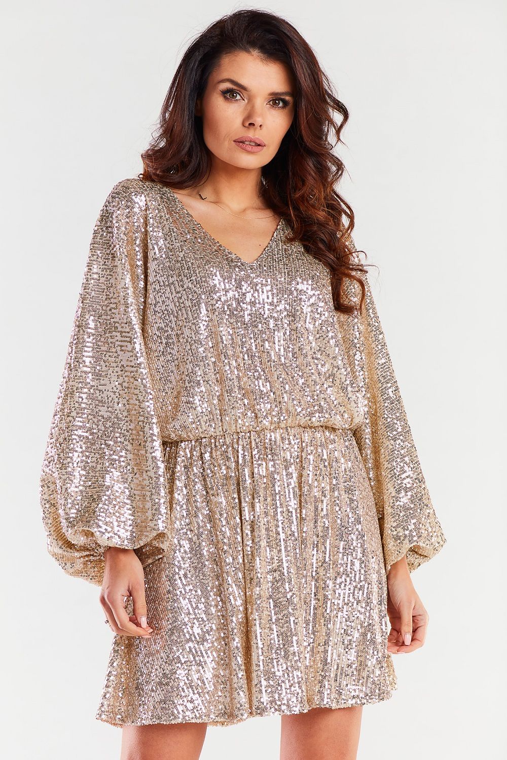 Chic front view of a gold sequin loose evening dress by Awama, featuring a cheeky neckline and wide sleeves, ideal for special events.