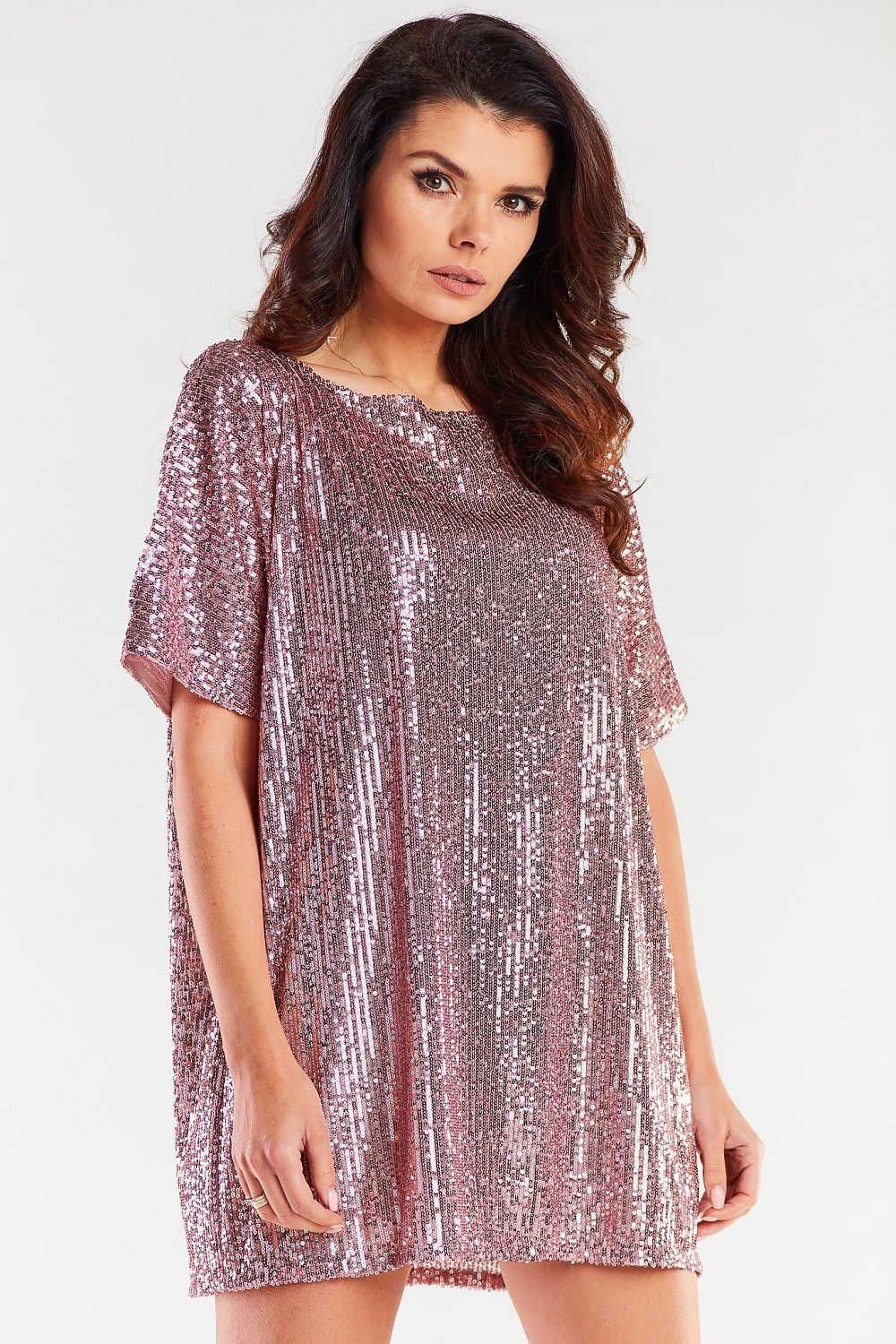 Stylish loose evening dress in shimmering rose gold sequins, featuring a flattering heart neckline. Designed for elegance and comfort, this dress exemplifies luxury fashion, perfect for special occasions. Crafted in Poland, it offers a chic and versatile fit for all body types.