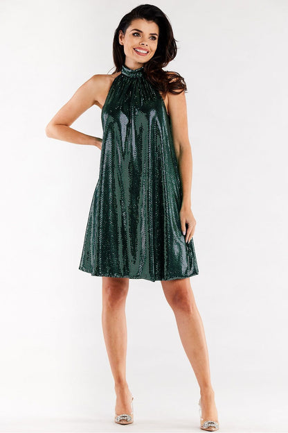 Chic green evening dress featuring a stylish ruffle neckline and flared design, ideal for upscale events, accentuated by a model's confident pose.