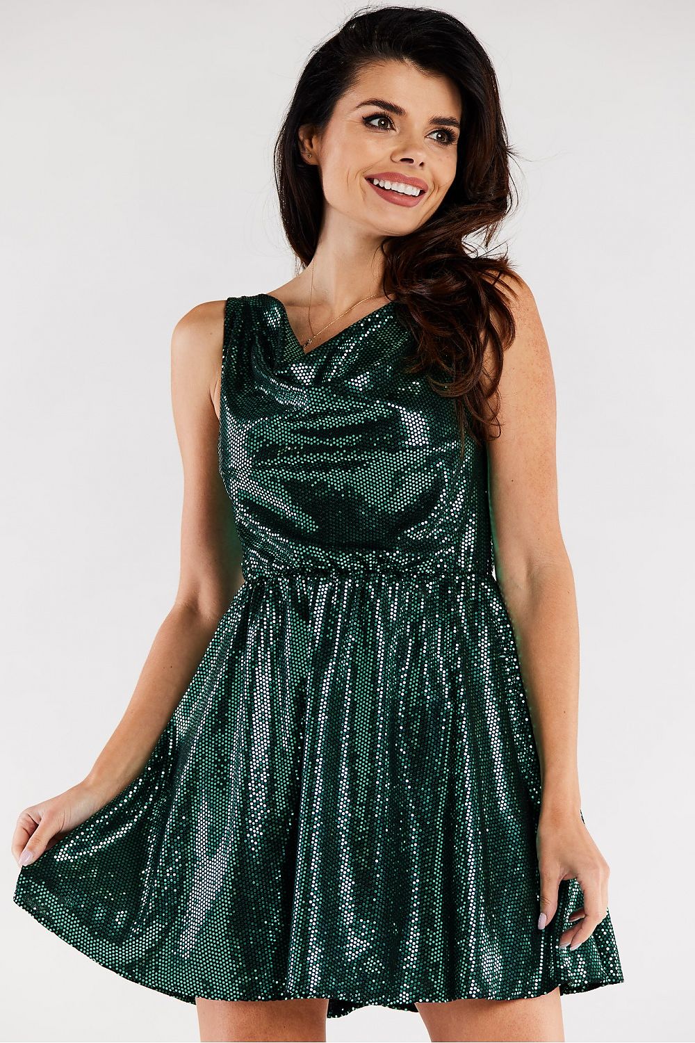 Elegant flared evening dress in rich green hue, featuring a ruffled neckline and shimmering fabric. Showcased on a model with styled hair, exuding sophistication, ideal for special occasions.