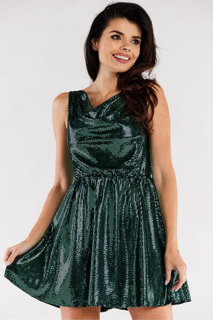 Elegant flared evening dress in rich green hue, featuring a ruffled neckline and shimmering fabric. Showcased on a model with styled hair, exuding sophistication, ideal for special occasions.