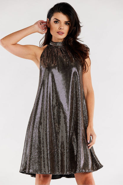 Beautiful model showcasing an elegant loose flared evening dress with a ruffle neckline, designed by Awama. The shimmering fabric creates a sophisticated look perfect for formal occasions.