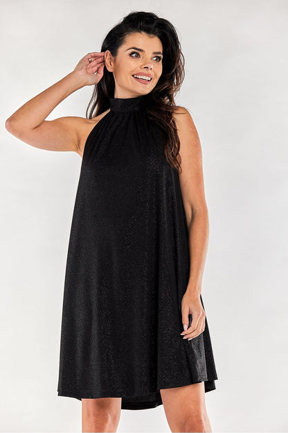 Sophisticated black flared evening dress with a decorative neckline, elegantly worn with a confident pose, ideal for glamorous events.