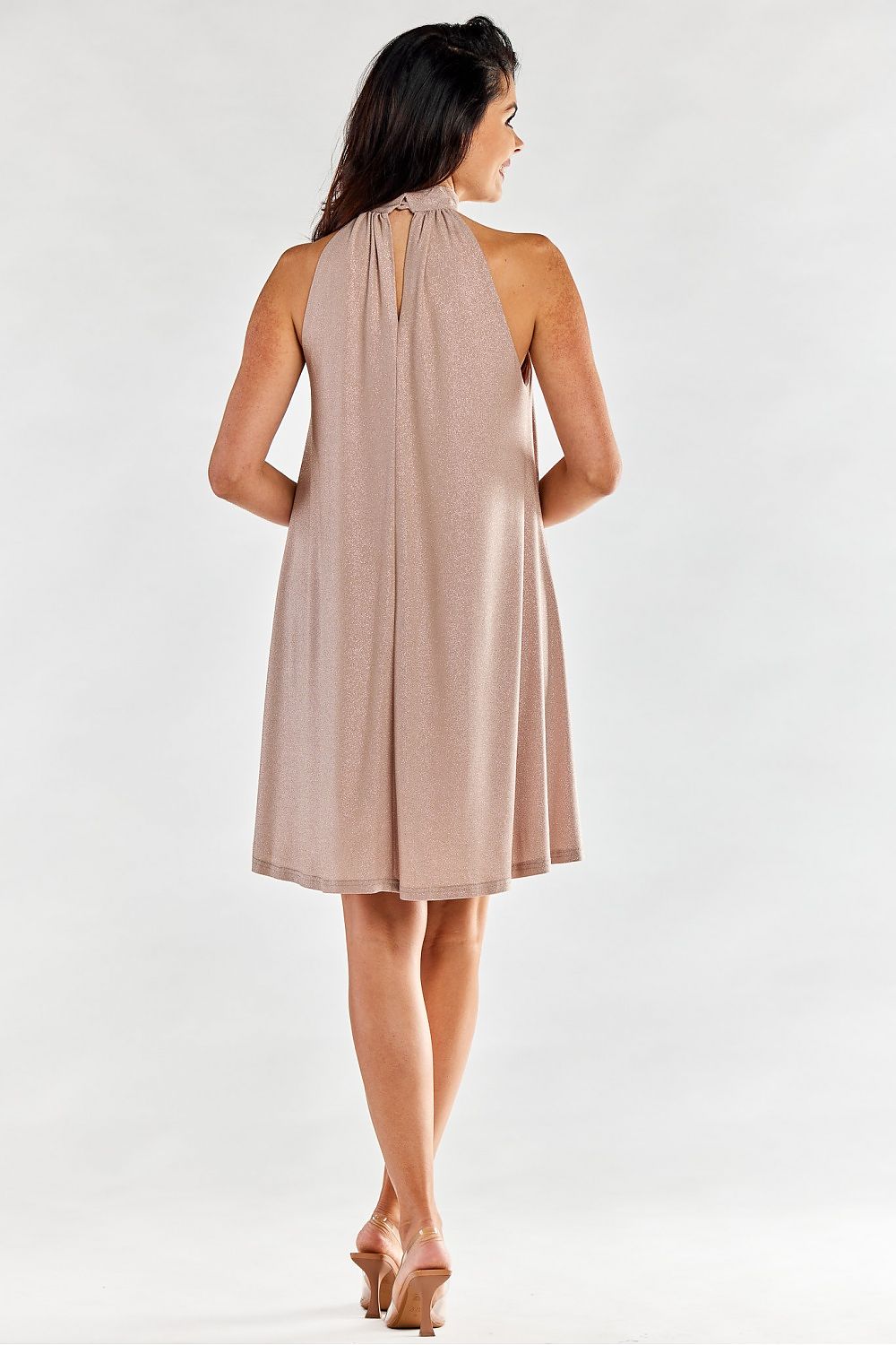 Stylish back view of an elegant flared evening dress with a decorative neckline and a keyhole detail. Model exuding grace and elegance, highlighting the quality craftsmanship of the garment.