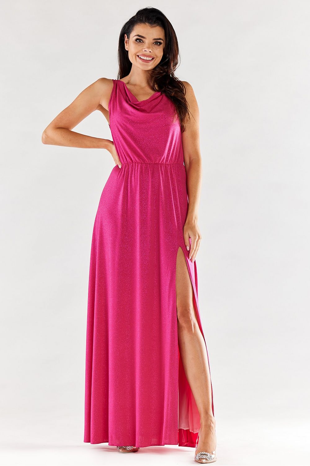 Elegant pink long dress with ruffled neckline and side slit, perfect for special occasions, showcasing a model smiling confidently.