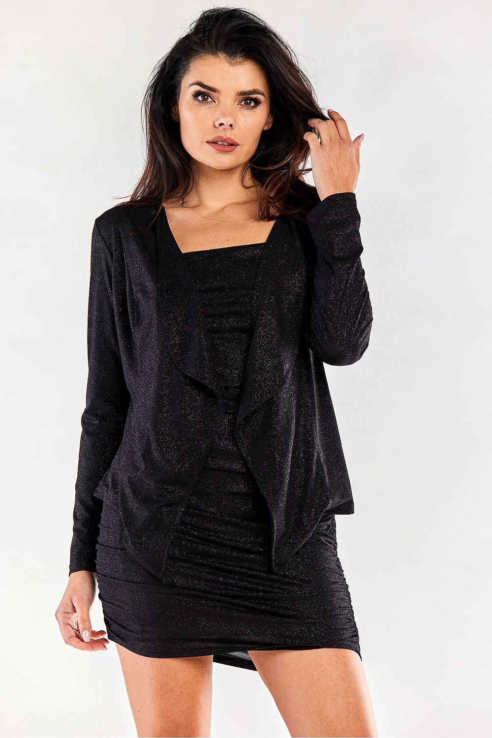 Elegant black loose-fitting long-sleeved bedspread jacket by Awama, showcasing a chic silhouette, paired perfectly with a stylish black dress.