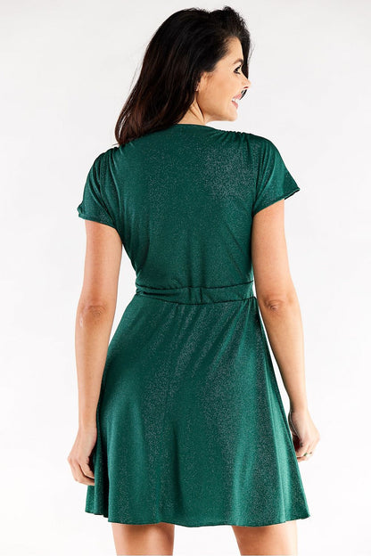 Back view of an exquisite green short flared evening dress by Awama with decorative creases, model showcases the elastic fit design gracefully.