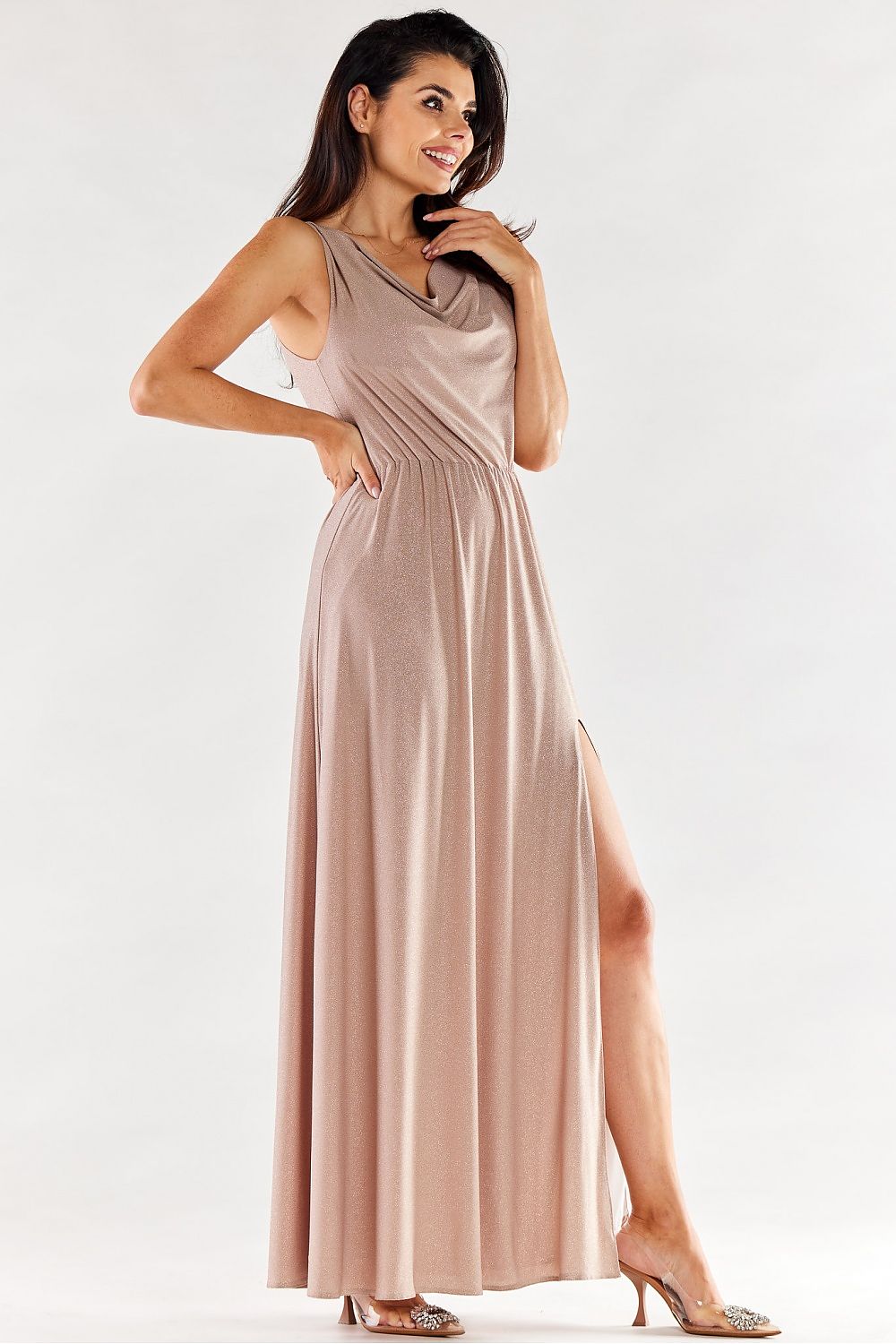 Side view of a glamorous long pink dress featuring a ruffled neckline and alluring side slit, radiating sophistication.