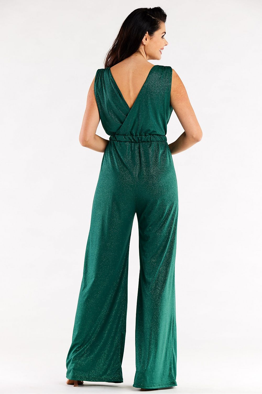 Back view of a glamorous green wide leg jumpsuit with an open V-back, accentuating the graceful design.