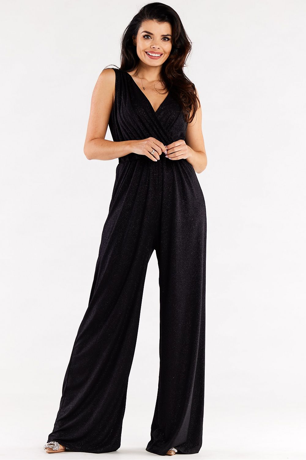 Chic black jumpsuit with sparkling fabric, featuring wide legs and a stylish envelope top, embodying elegance.