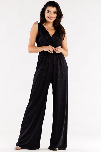 Chic black jumpsuit with sparkling fabric, featuring wide legs and a stylish envelope top, embodying elegance.