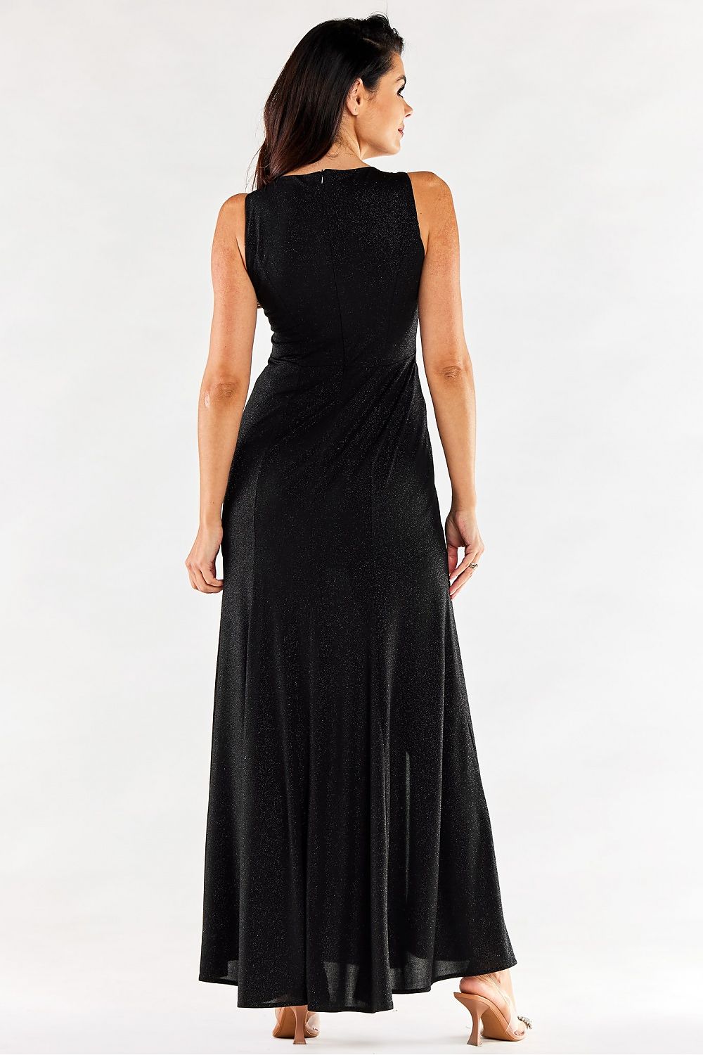 Back view of an elegant long black dress by Awama with slits, highlighting the fitted silhouette on a model.