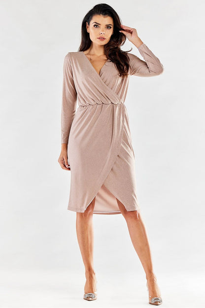 Exquisite nude envelope dress shown in a confident pose, highlighting its sleek silhouette and luxurious fabric, perfect for upscale events.