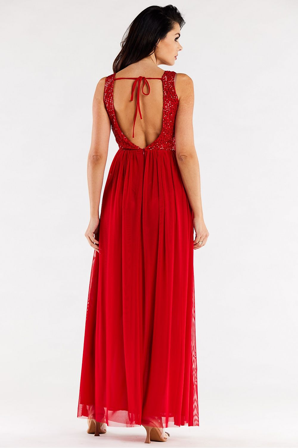 Back view of the luxurious red long dress by Awama, showcasing its stunning open back design with sequins and mesh accents.
