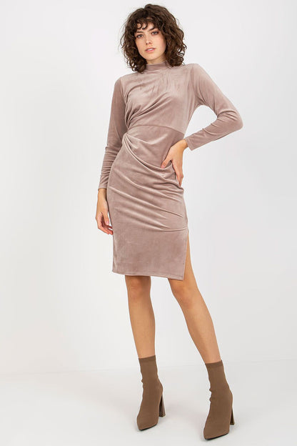 Sophisticated front view of a luxurious velvet evening dress by Rue Paris in a delicate taupe shade, featuring long sleeves and a stylish twist design.