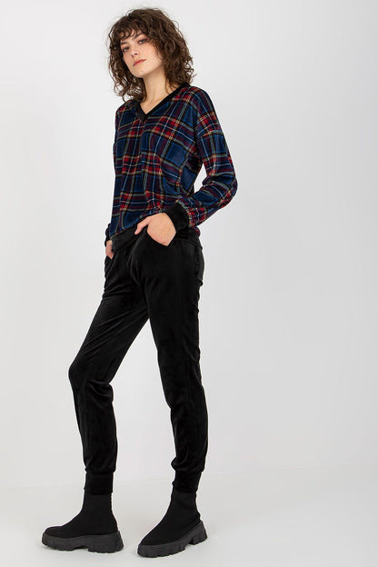 Elegant women's velour outfit featuring a stylish checkered long-sleeved blouse in navy and red paired with chic black pants, perfect for a sophisticated casual look.