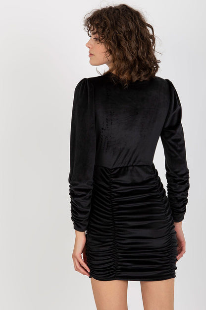 Rear view of a luxurious black velour evening dress with long sleeves and decorative ruched details, offering elegance for special occasions.