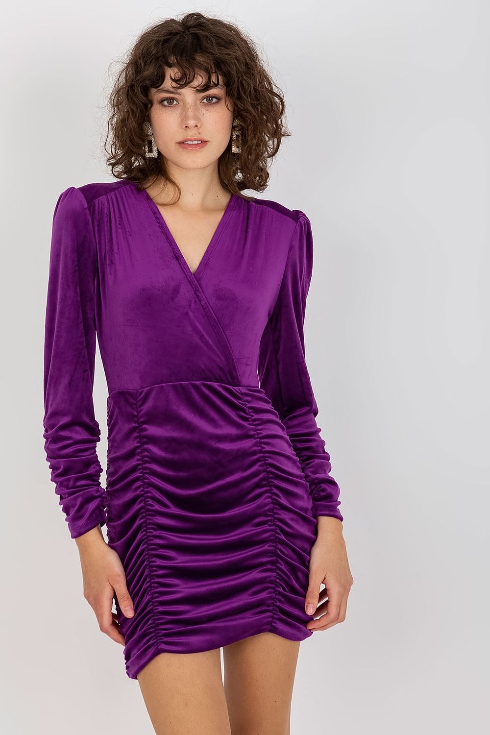 Front view of a stunning purple velour evening dress featuring a deep V-neck and ruched detailing, perfect for a glamorous night out.