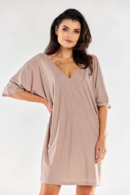 Chic nude loose evening dress with elegant V-neck and short sleeves, capturing a radiant and refined style.