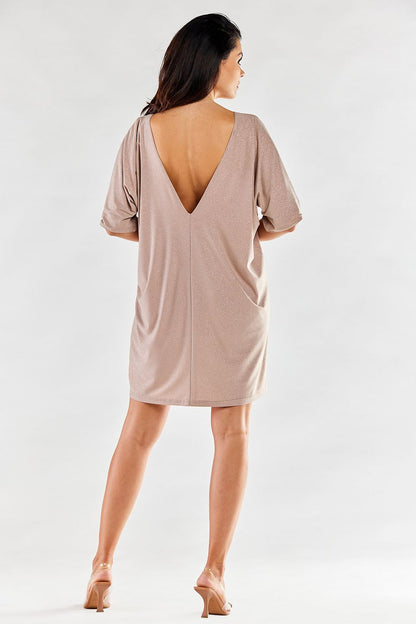 Back view of a graceful nude evening dress showcasing a deep V-neck and short sleeves, epitomising elegant evening wear.