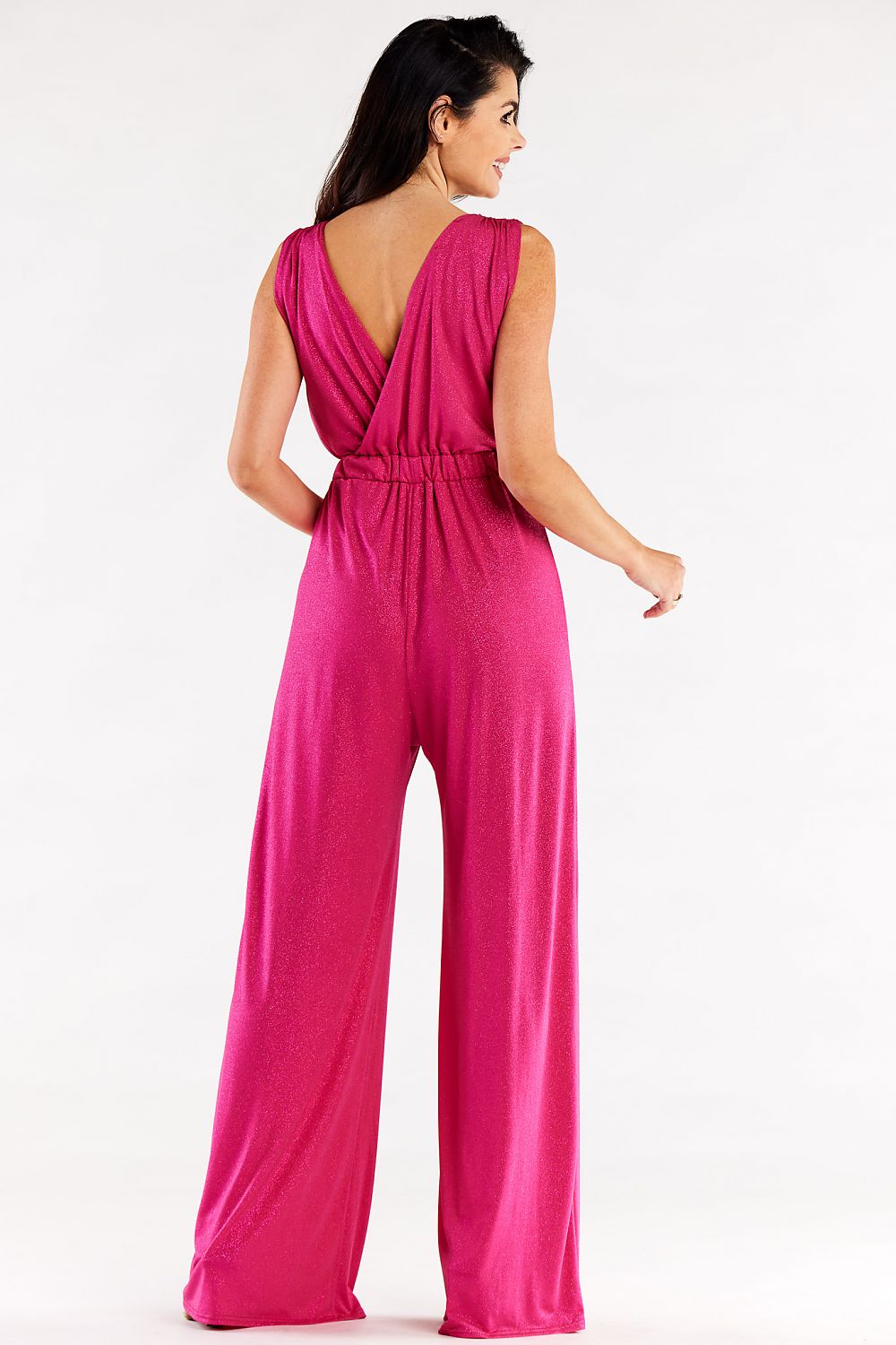 Back view of a chic pink wide leg jumpsuit with an envelope style top, highlighting its elegant design and flowing fabric, ideal for evening events.