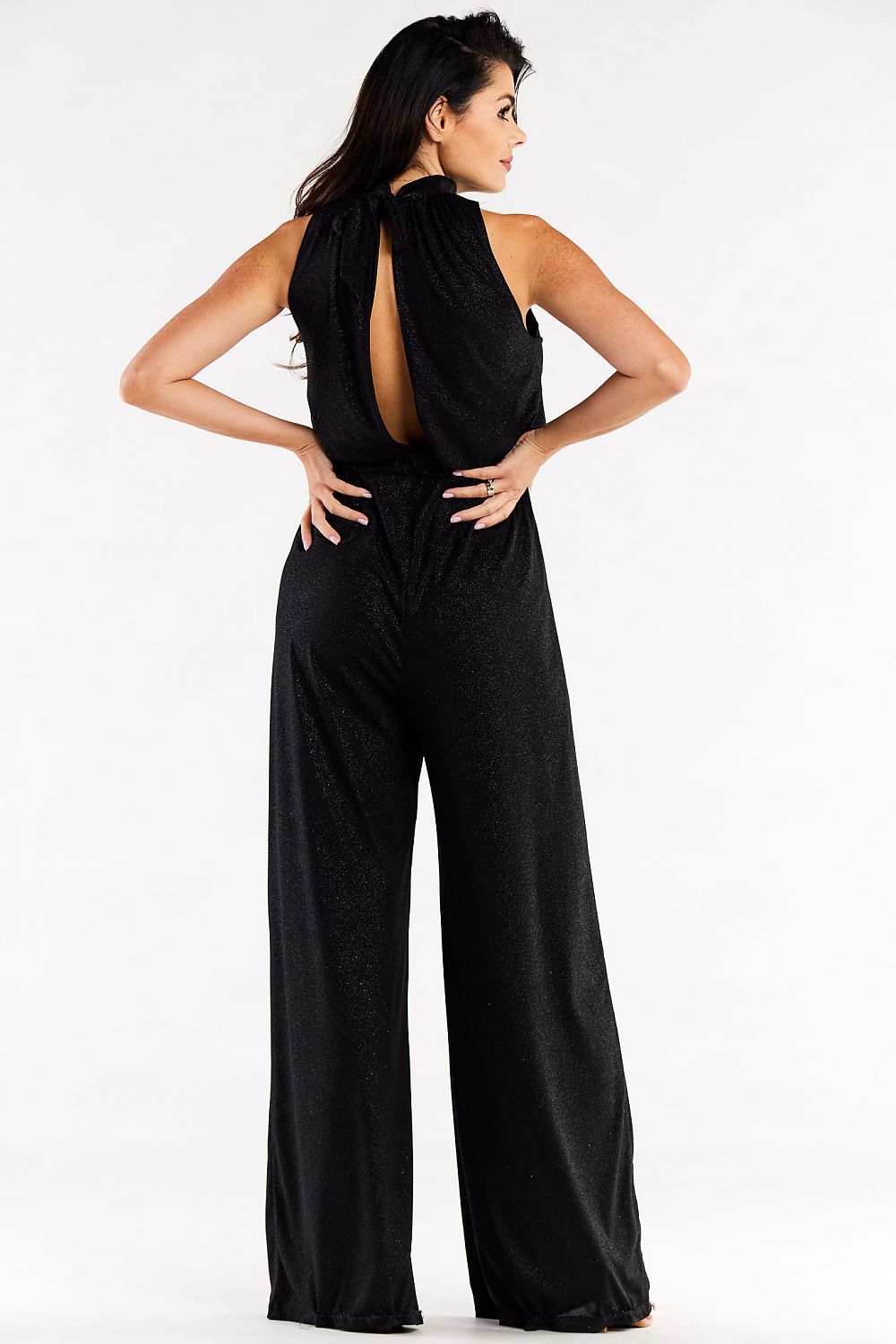 Elegant black wide-leg suit with crinkled neckline and back slit, showcasing a luxurious design on a model.