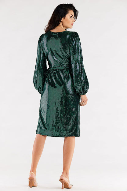 Back view of a chic green metallic dress with crinkled long sleeves and a stylish belt, showcasing its luxurious design for evening wear.