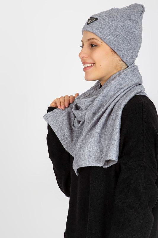 Chic profile of a model wearing a grey Angora and spandex hat and scarf, beautifully styled for elegant winter wear. The model exhibits a confident smile, complementing the sophisticated look.