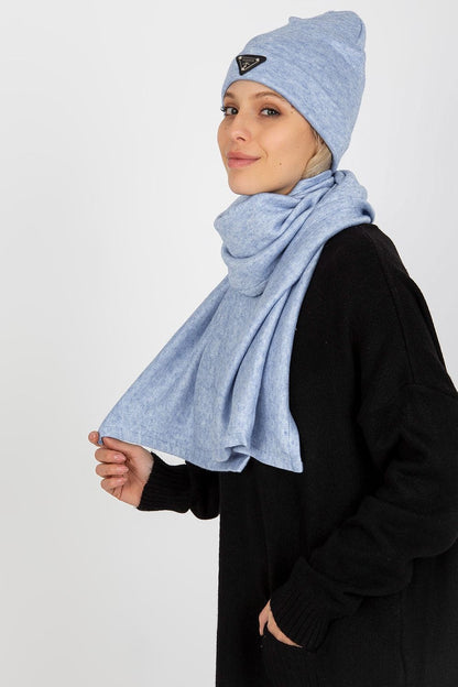 Close-up of an elegant woman wearing a luxurious blue Lakerta Angora and Spandex winter hat and scarf, styled with a black oversized sweater, highlighting the chic design and soft texture.