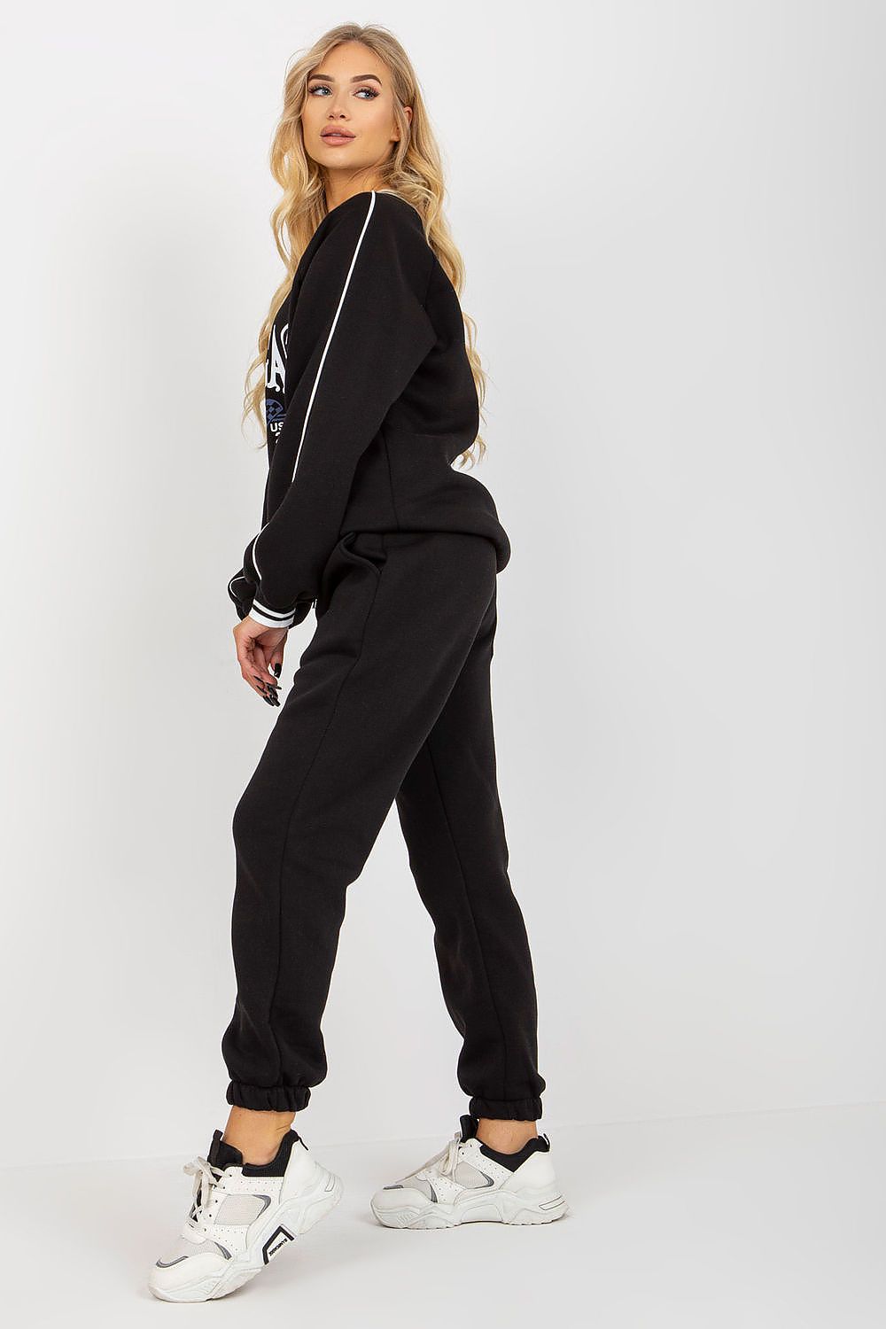 Fashion-forward black sweatshirt set with a sporty vibe, complemented by a refined silhouette and chic batch details, exuding luxury in casual wear.
