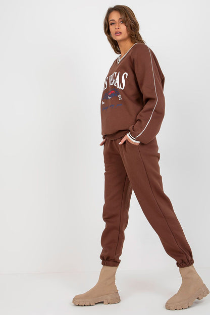 Chic brown cotton blend sweatshirt set featuring long sleeves and tapered pants, styled with trendy beige footwear against a minimalist background, perfect for casual luxury.