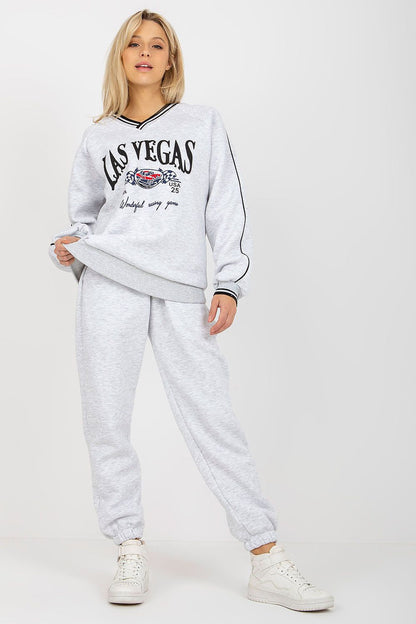 Luxurious grey cotton blend sweatshirt set showcasing a bold 'Las Vegas' print, paired with relaxed-fit pants and chic white sneakers for an effortlessly stylish look.