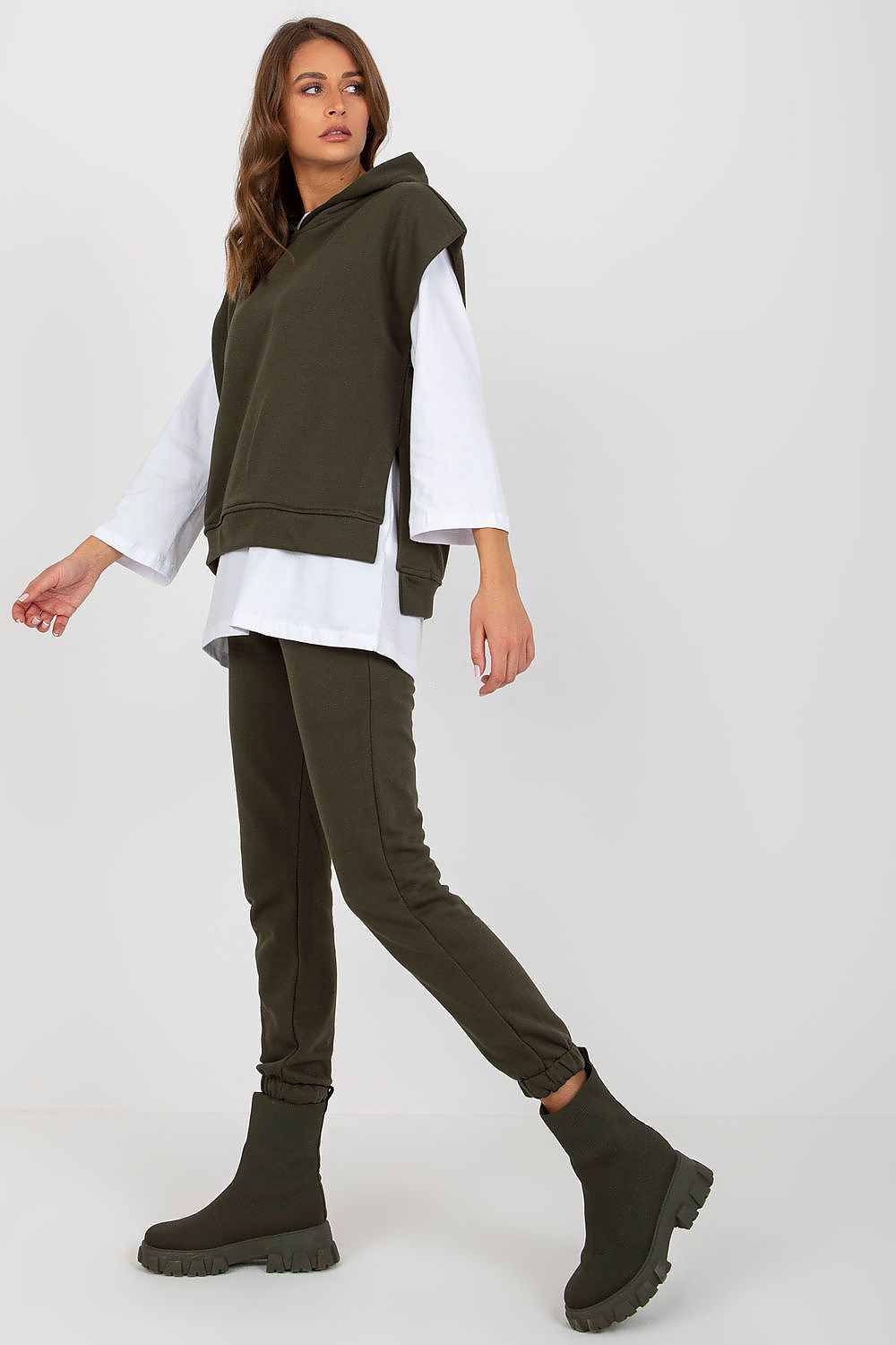 Elegantly styled olive green 3-piece sweatsuit set featuring a hooded blouse and long pants paired with designer ankle boots, perfect for chic casual wear.
