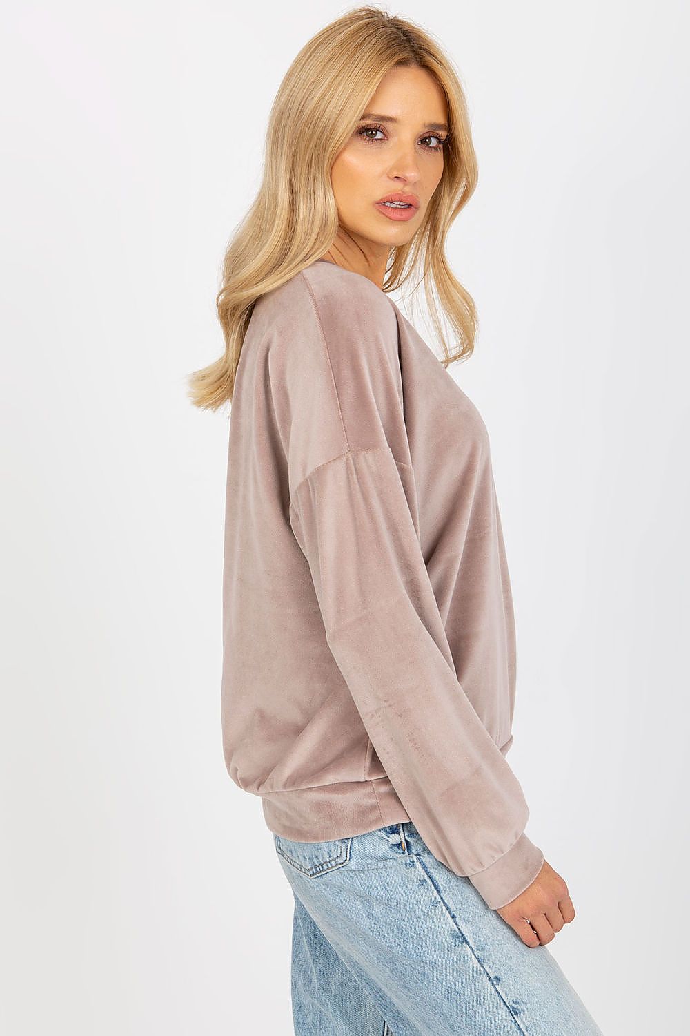 Side profile of a light taupe velour women's sweatshirt highlighting its luxurious texture and elegant heart neckline.