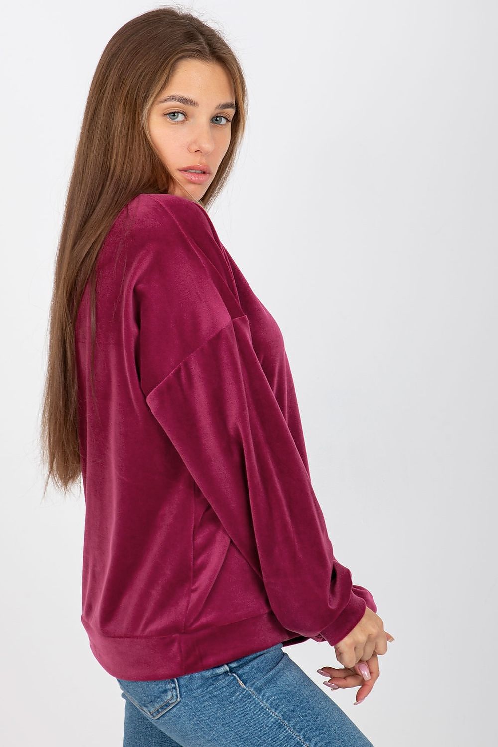 Stylish women's velour sweatshirt in burgundy, featuring an elegant V-neck and flowing sleeves for a refined yet casual outfit.