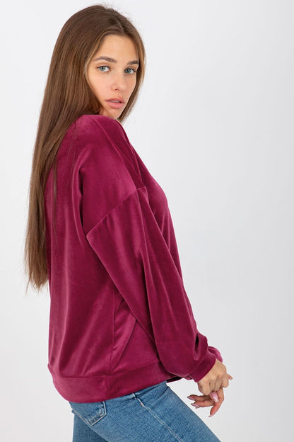 Stylish women's velour sweatshirt in burgundy, featuring an elegant V-neck and flowing sleeves for a refined yet casual outfit.