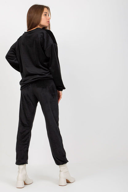 Sophisticated back view of a women's black velour outfit, highlighting the luxurious texture and modern fit.